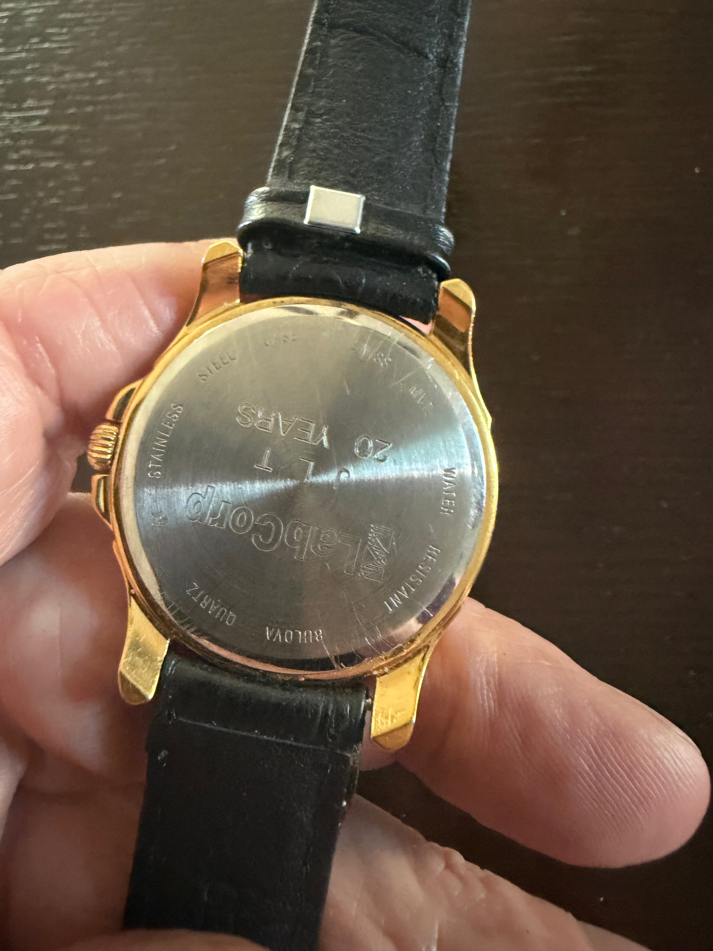 Bulova Men’s Gold Tone Quartz Dress Watch Day Date White Dial Black Leather Strap