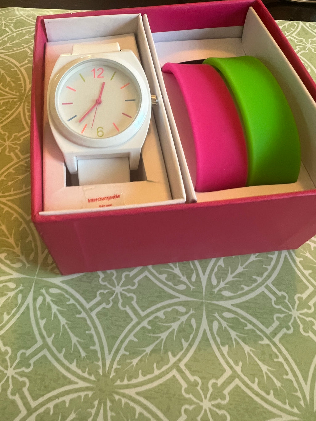 Ladies white with multicolored trim watch. Interchangeable pink and green straps
