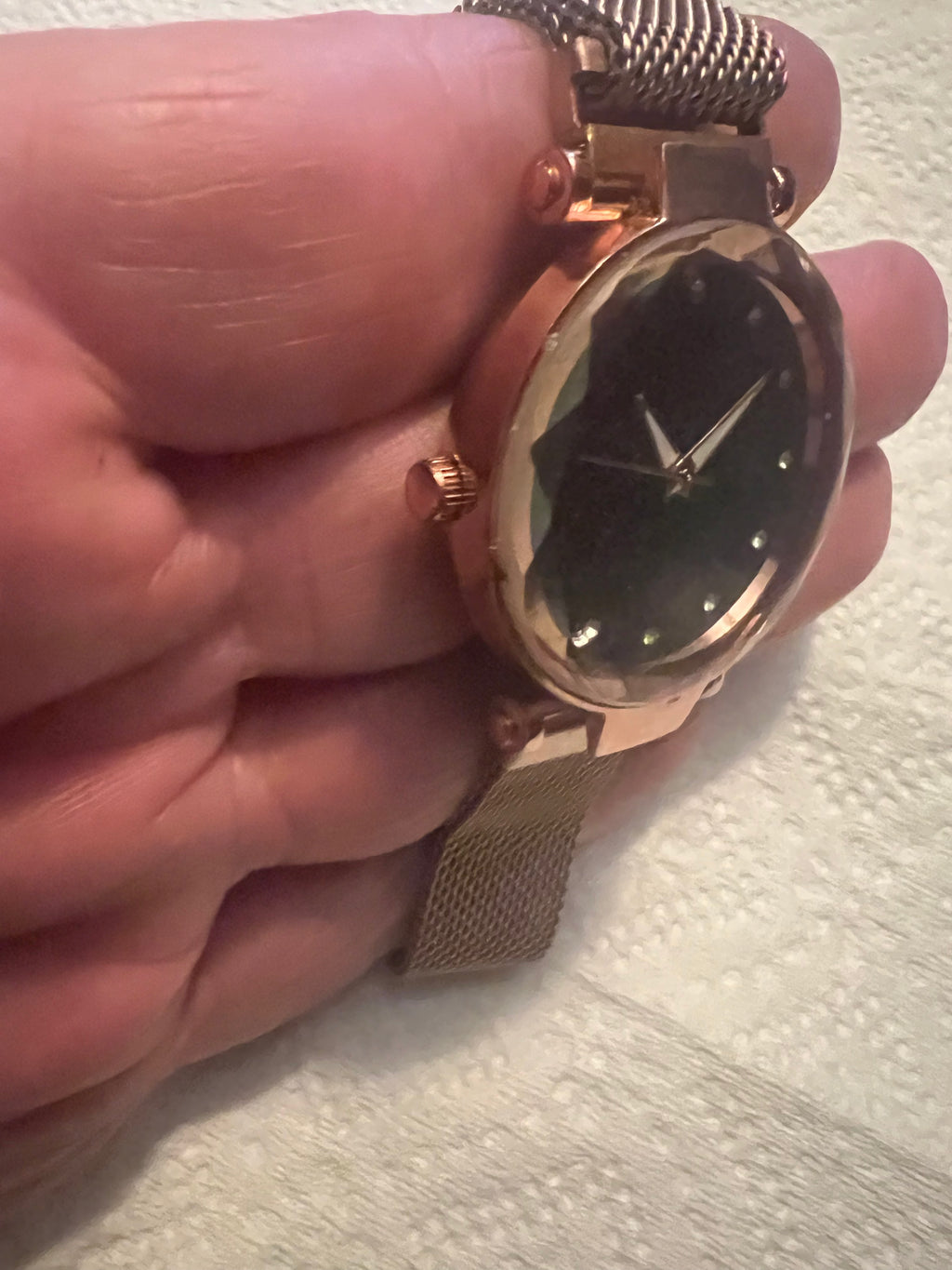 women's rose gold-toned quartz watch featuring a black "starry sky" glitter dial and a magnetic mesh strap.