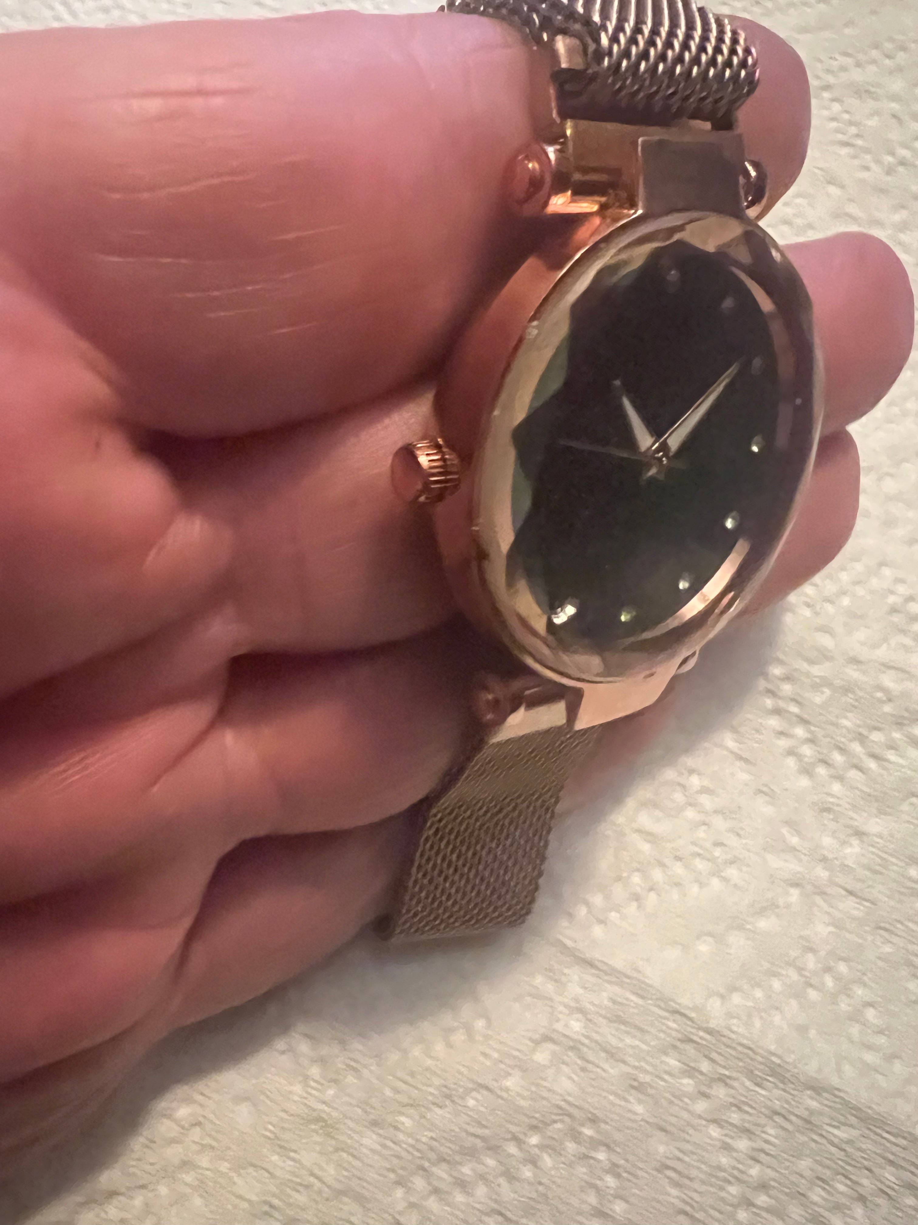 women's rose gold-toned quartz watch featuring a black "starry sky" glitter dial and a magnetic mesh strap.