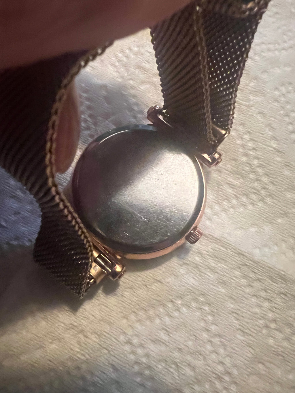 women's rose gold-toned quartz watch featuring a black "starry sky" glitter dial and a magnetic mesh strap.