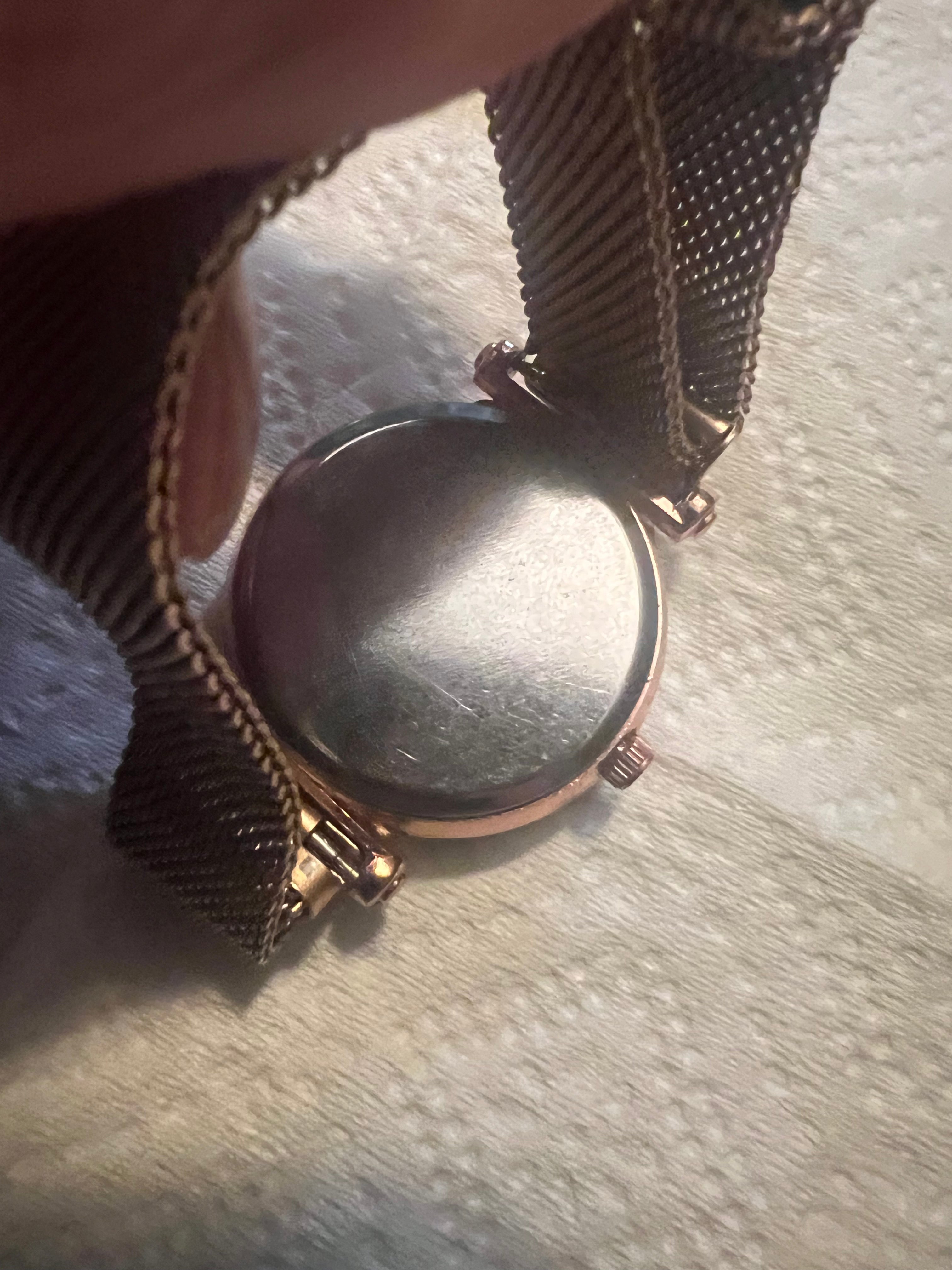 women's rose gold-toned quartz watch featuring a black "starry sky" glitter dial and a magnetic mesh strap.