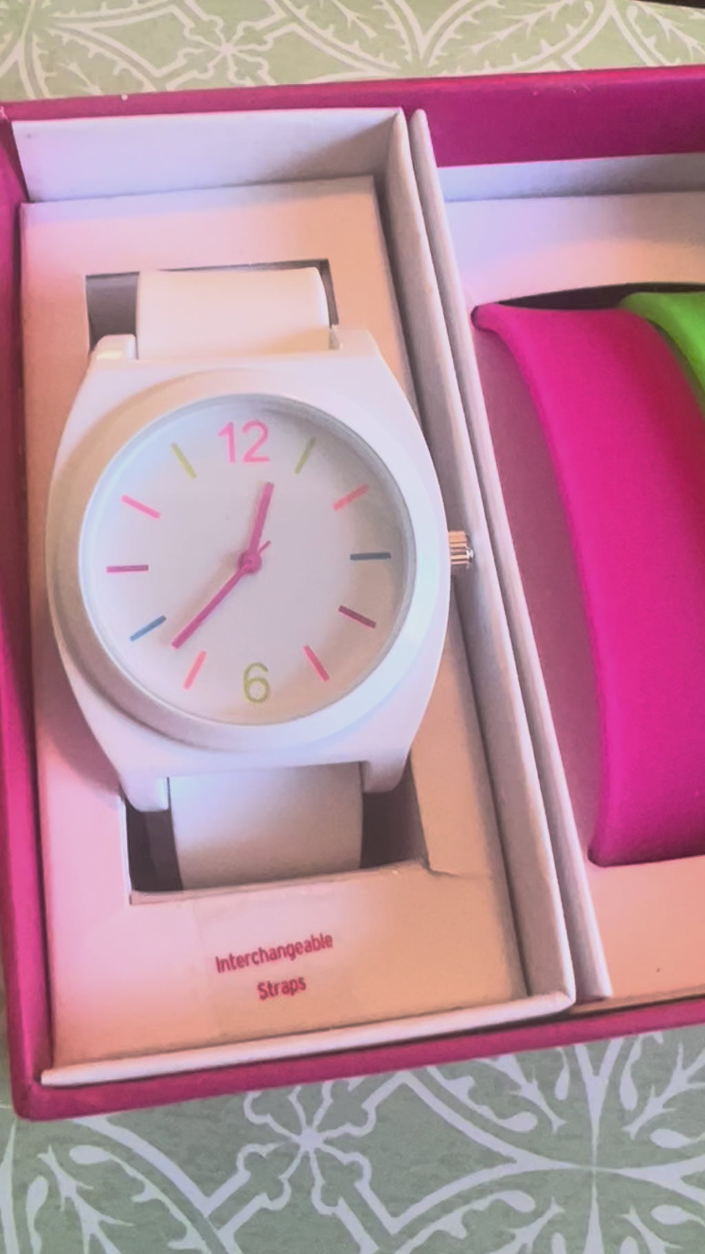 Ladies white with multicolored trim watch. Interchangeable pink and green straps